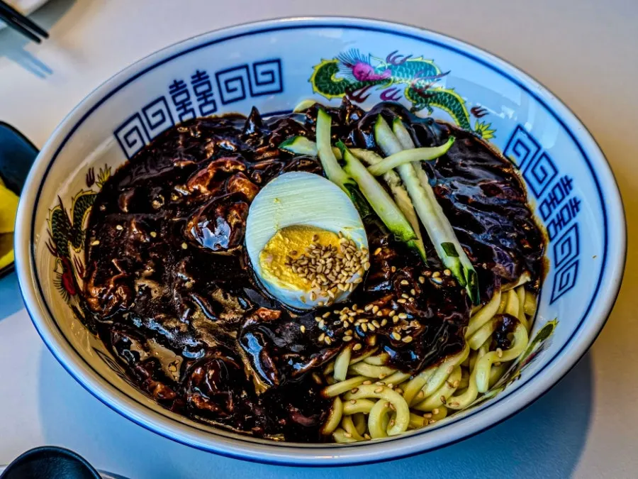 BUUK jjajangmyeon topped with boiled egg and cucumber