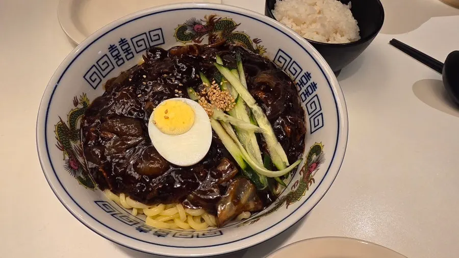 Table spread with jjajangmyeon, tangsuyuk and seafood jjamppong rice