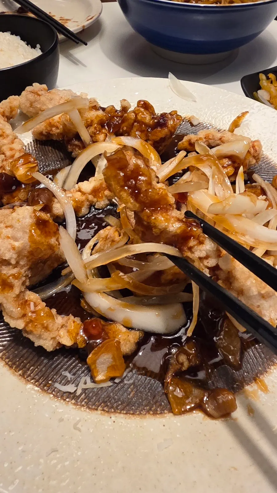 Close-up of black vinegar tenderloin tangsuyuk topped with onions