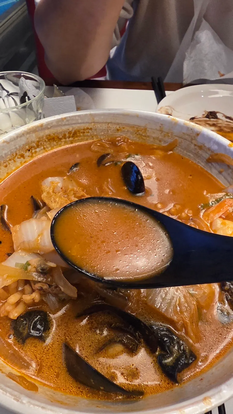 Spoonful of seafood scooped up from the jjamppong