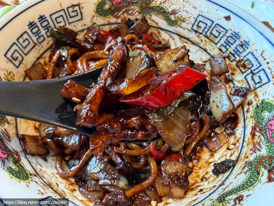 Eohyang mandu topped with sweet-savory sauce and onion strips