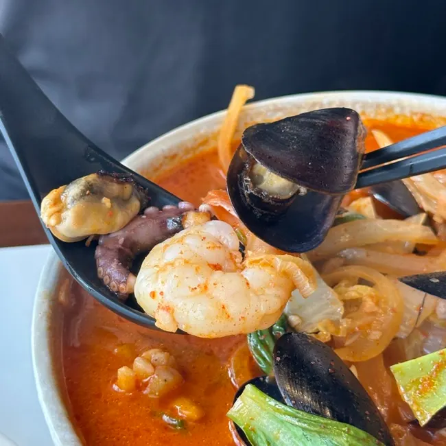 Seafood jjamppong toppings of shrimp, mussels, and octopus