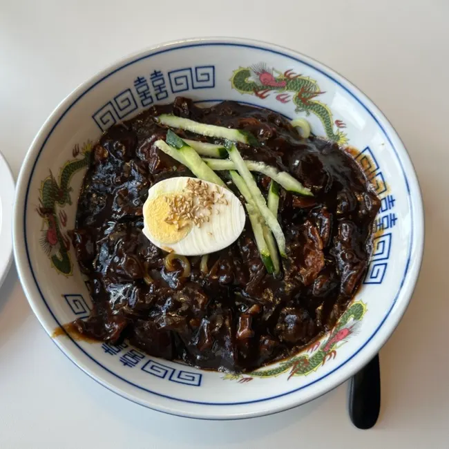 Lifting a bite of jjamppong noodles