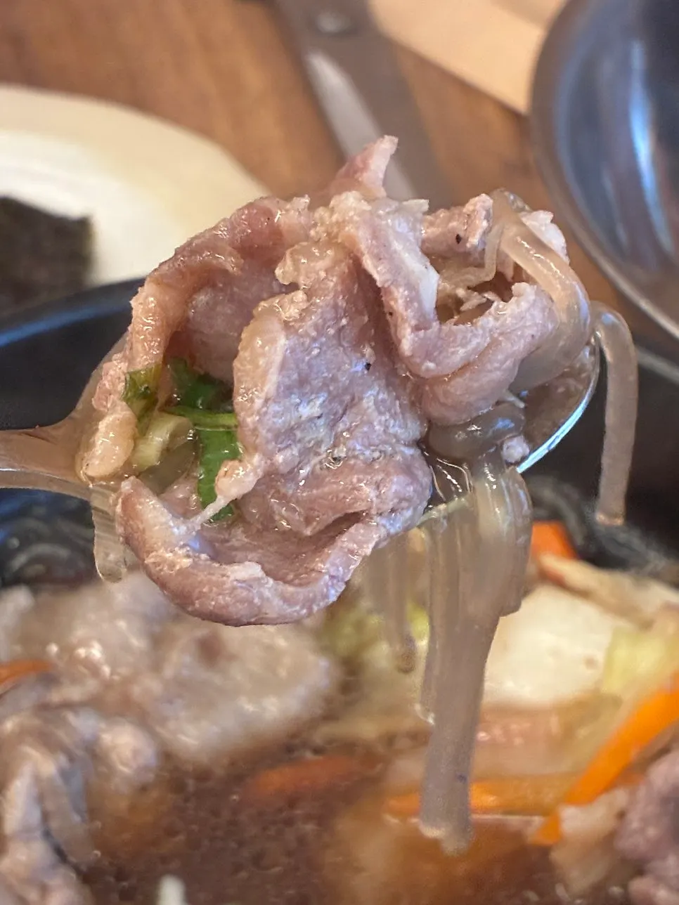 A bite of bulgogi on chopsticks