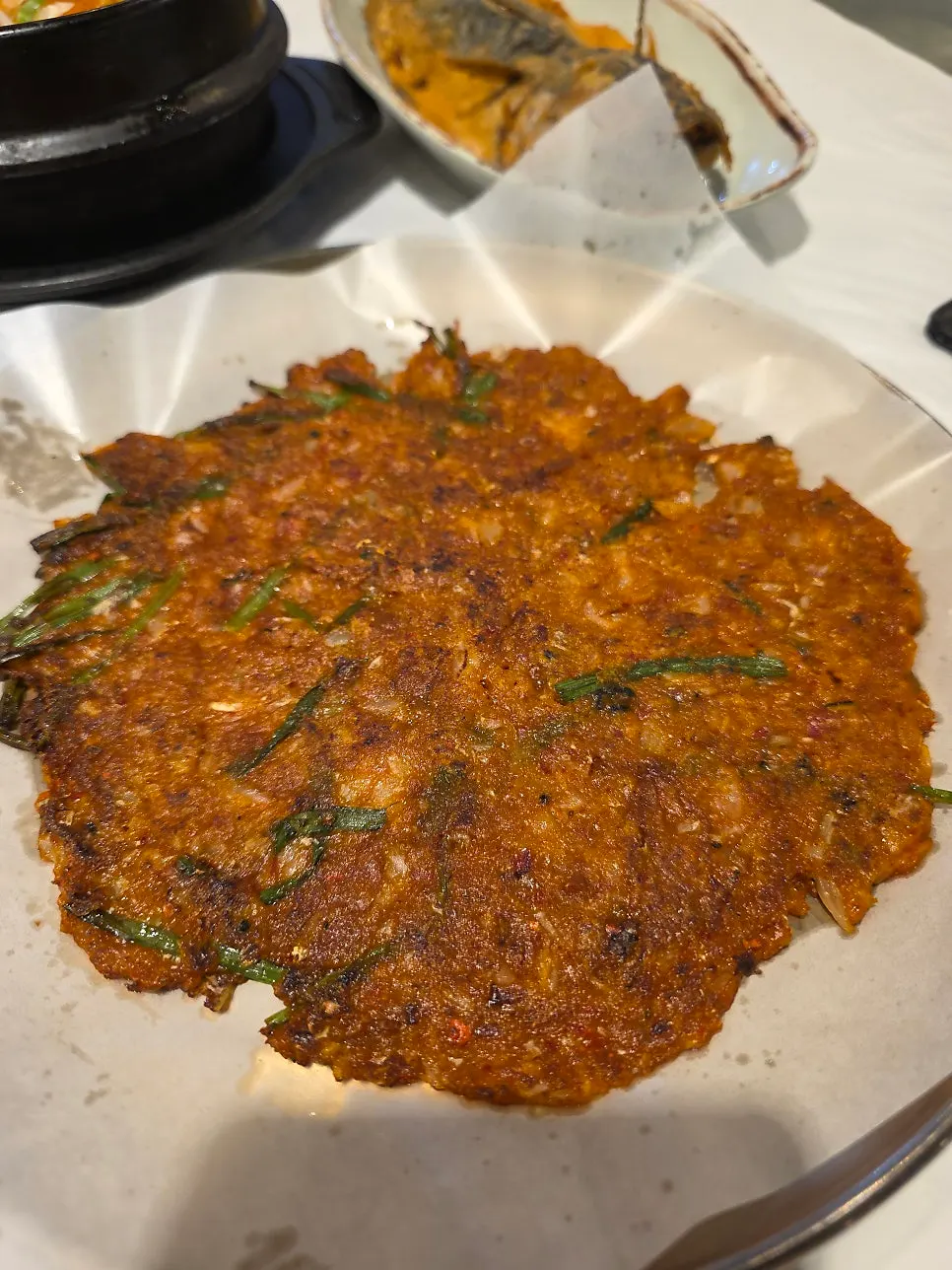 A full table of warm side dishes at Yun Sikdang