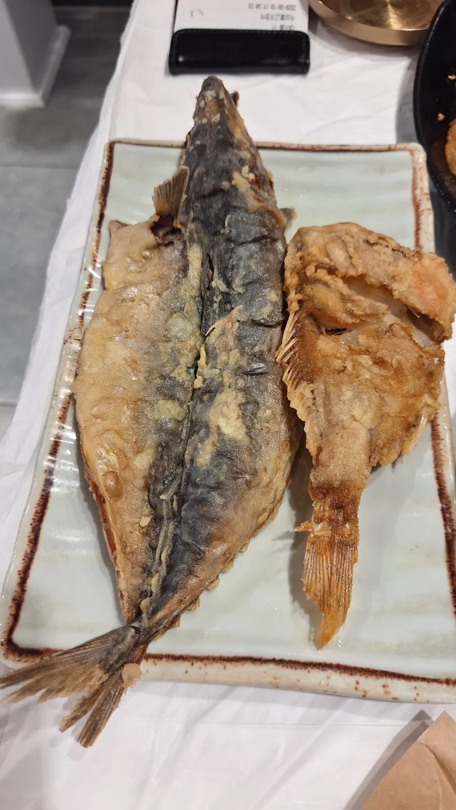Crisply grilled fish served as part of the standard banchan