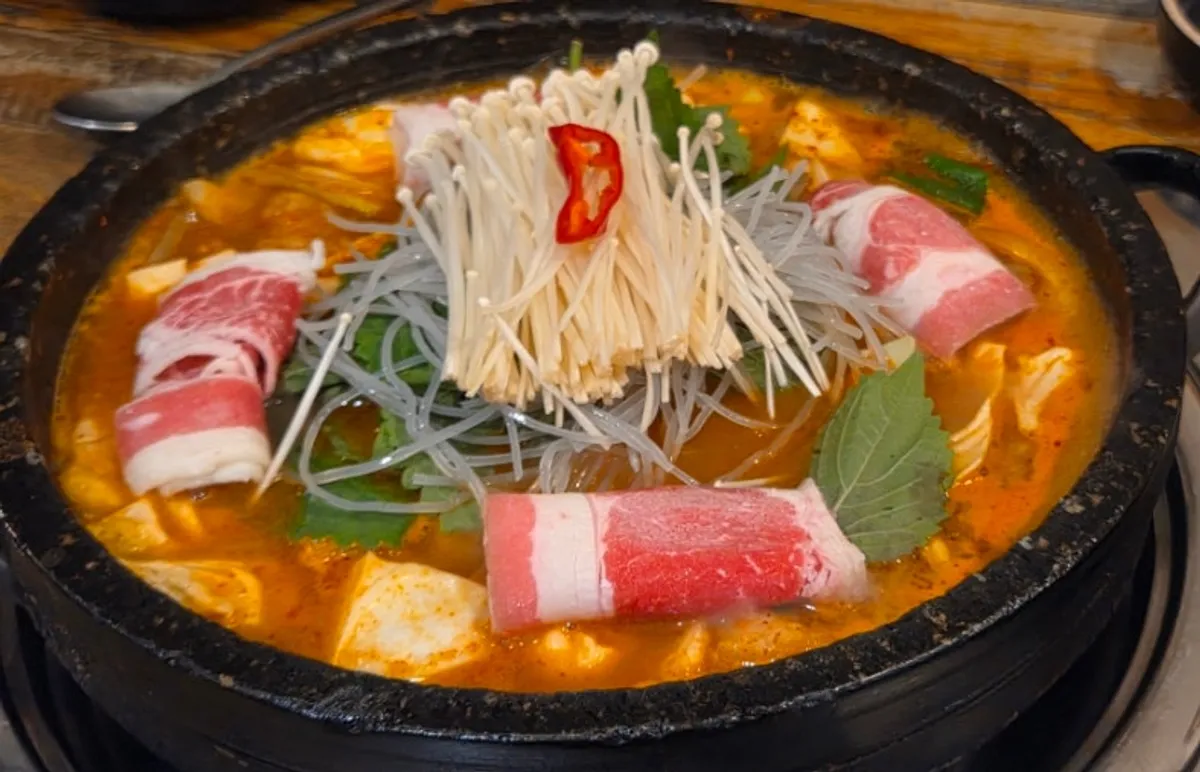 Beef tripe hotpot topped with enoki mushrooms