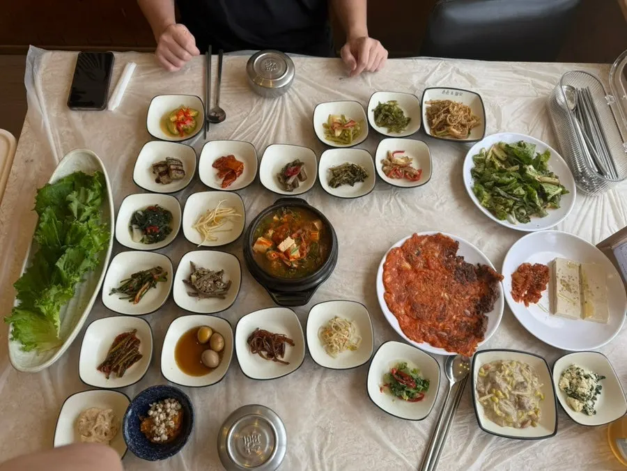 Full table spread with about 30 side dishes