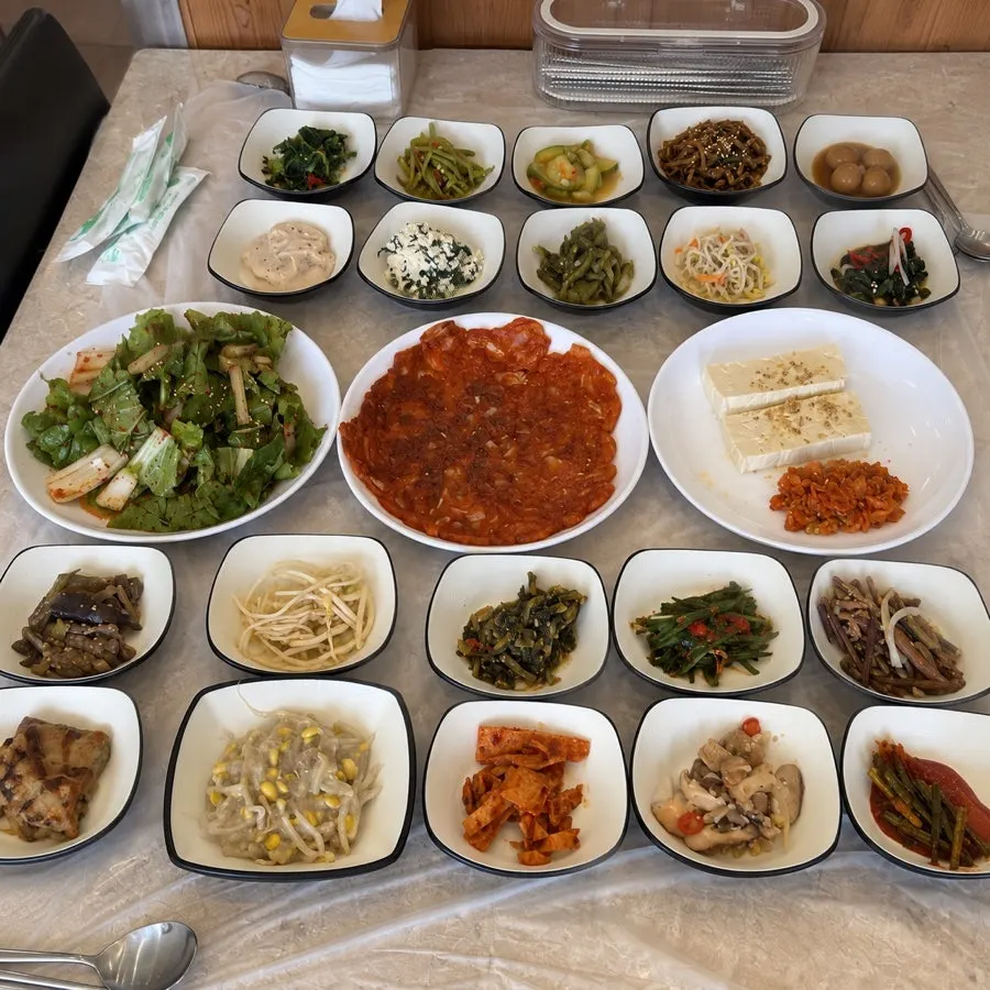 A table fully spread with 30 side dishes