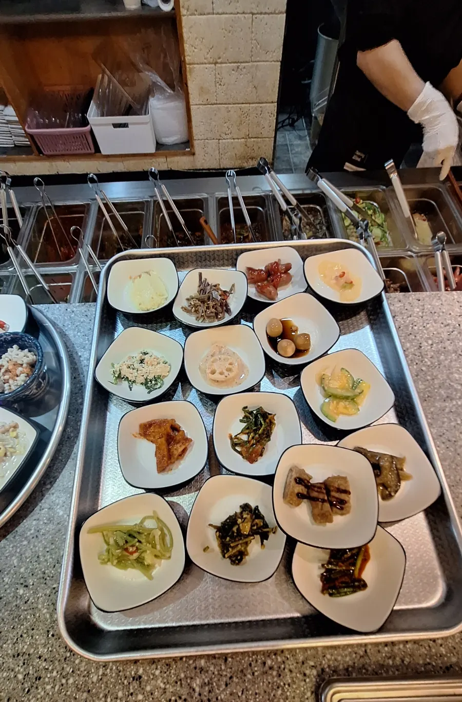 Staff plating side dishes to be served, next to the self-serve bar