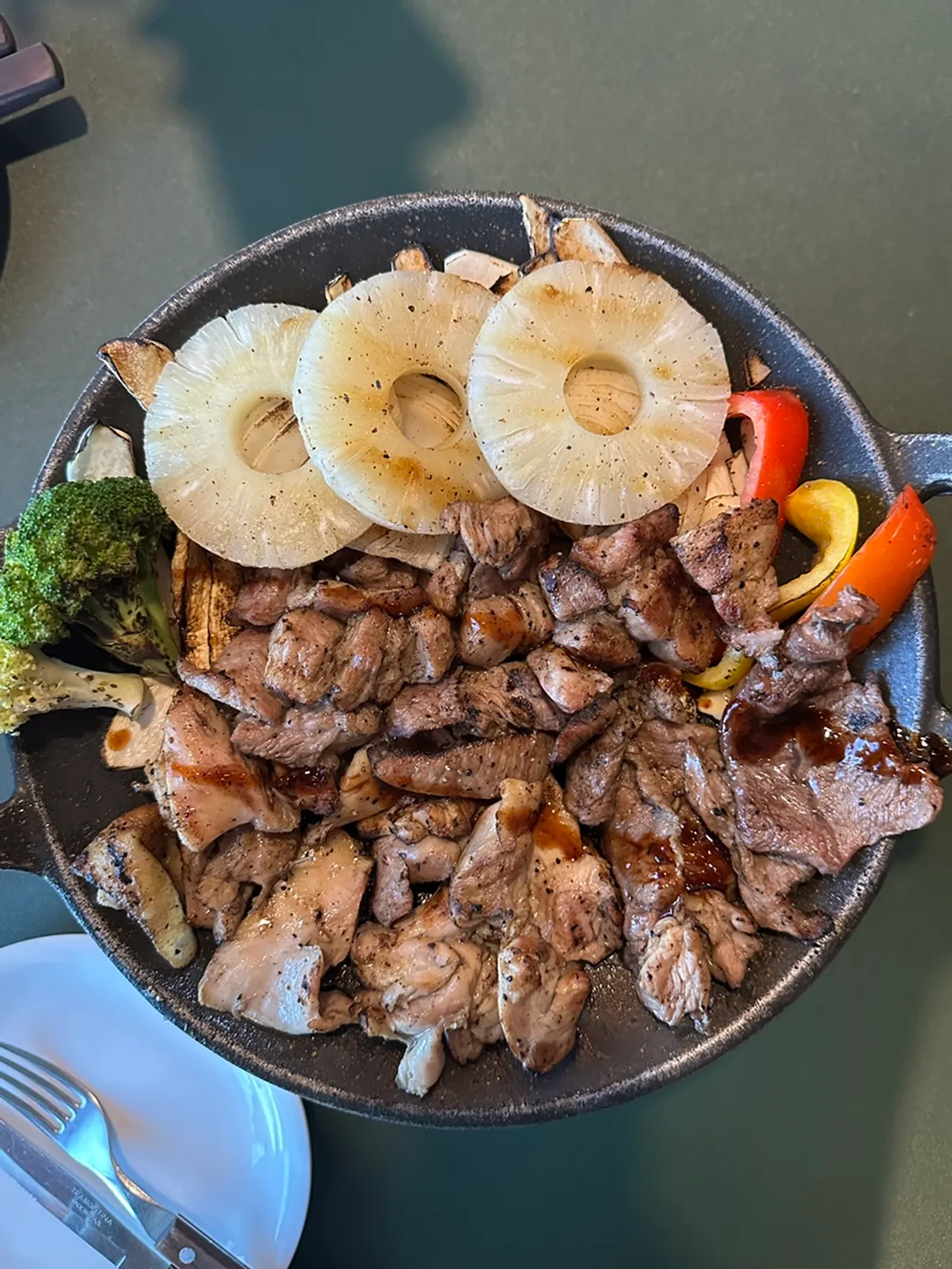Garlic, mustard, chili, and teriyaki sauces with pickles on the table