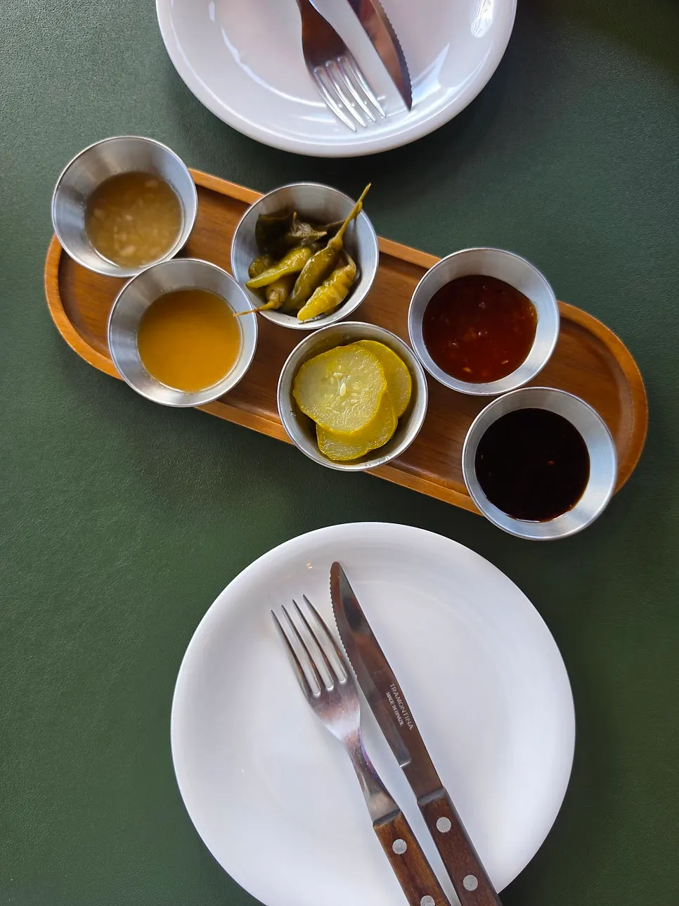 Table setting with side dishes and four sauces