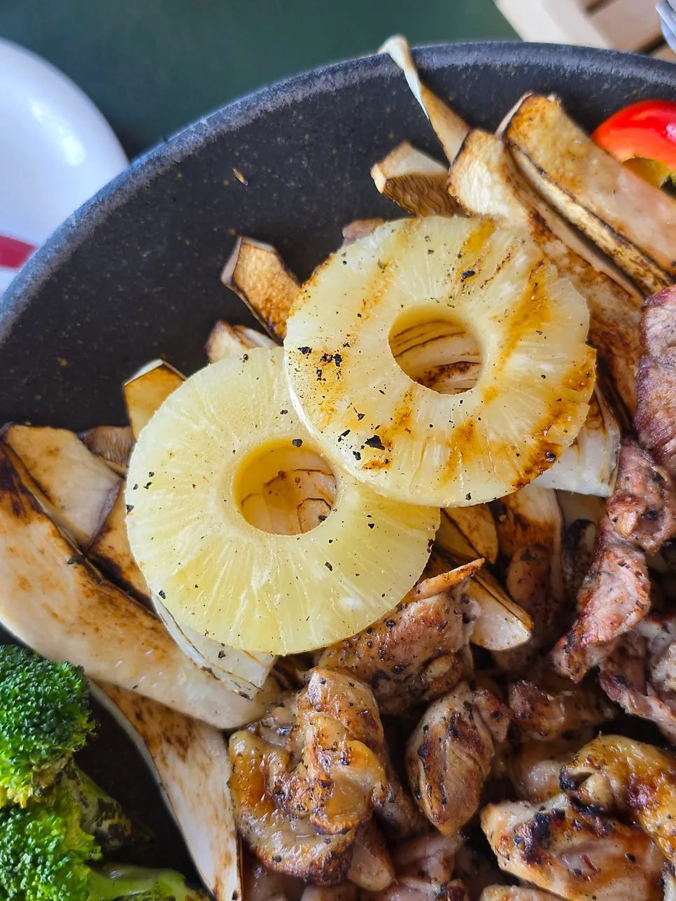 Grilled pineapple served alongside the shashlik