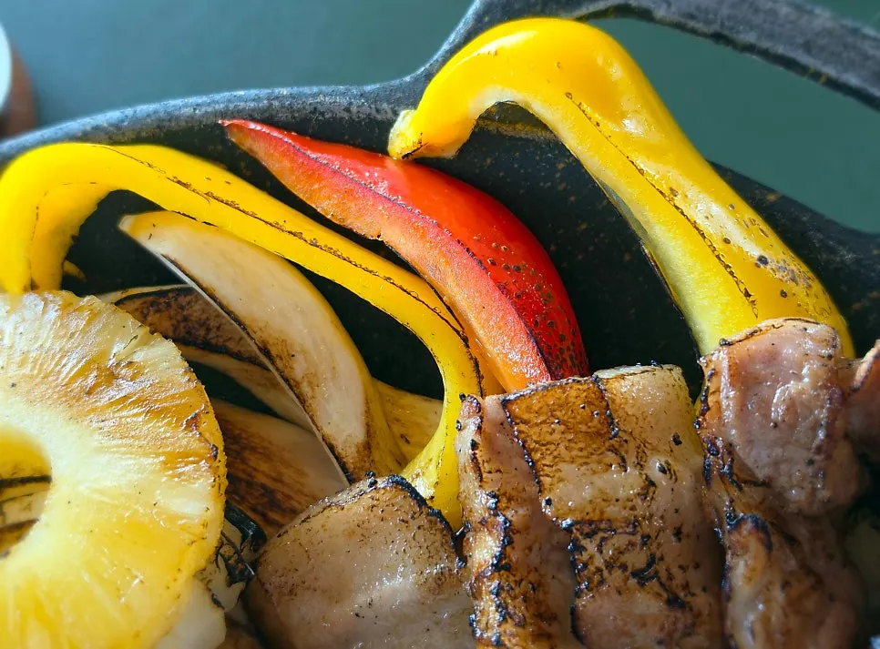 Griddle full of charcoal-grilled shashlik with garnish