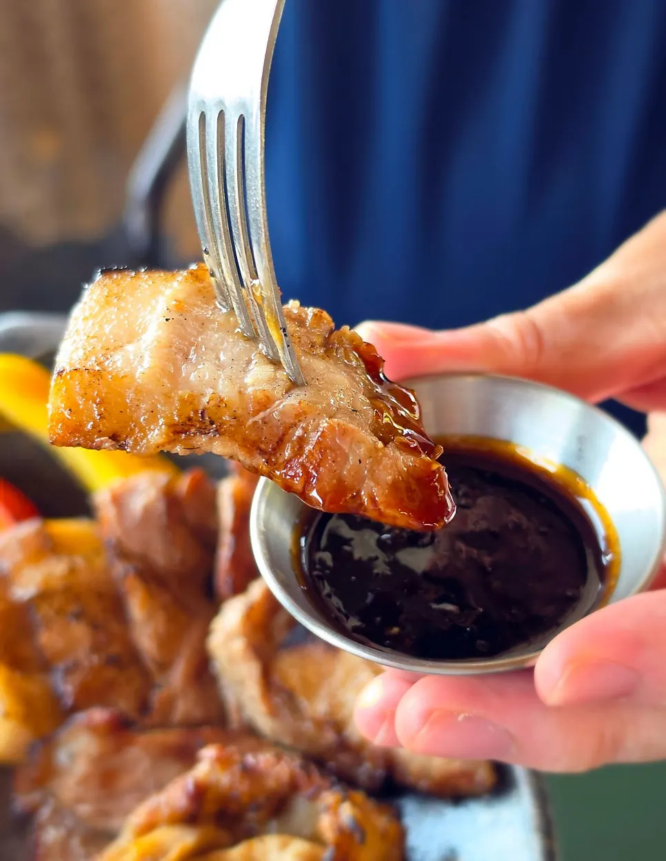 A bite of charcoal-grilled meat paired with special sauce