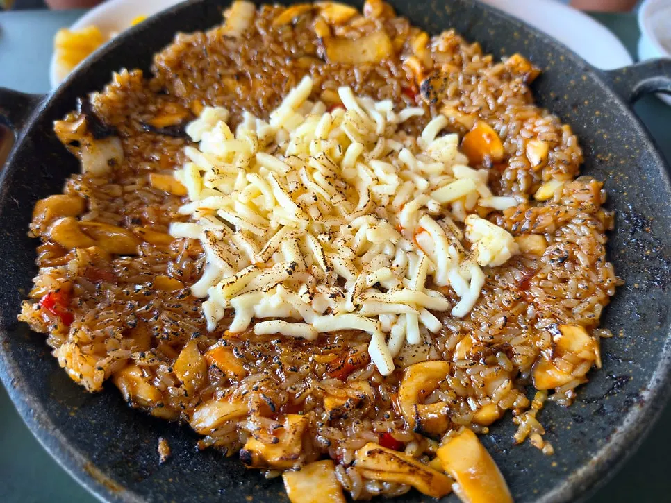 Cheese fried rice cooking on the griddle