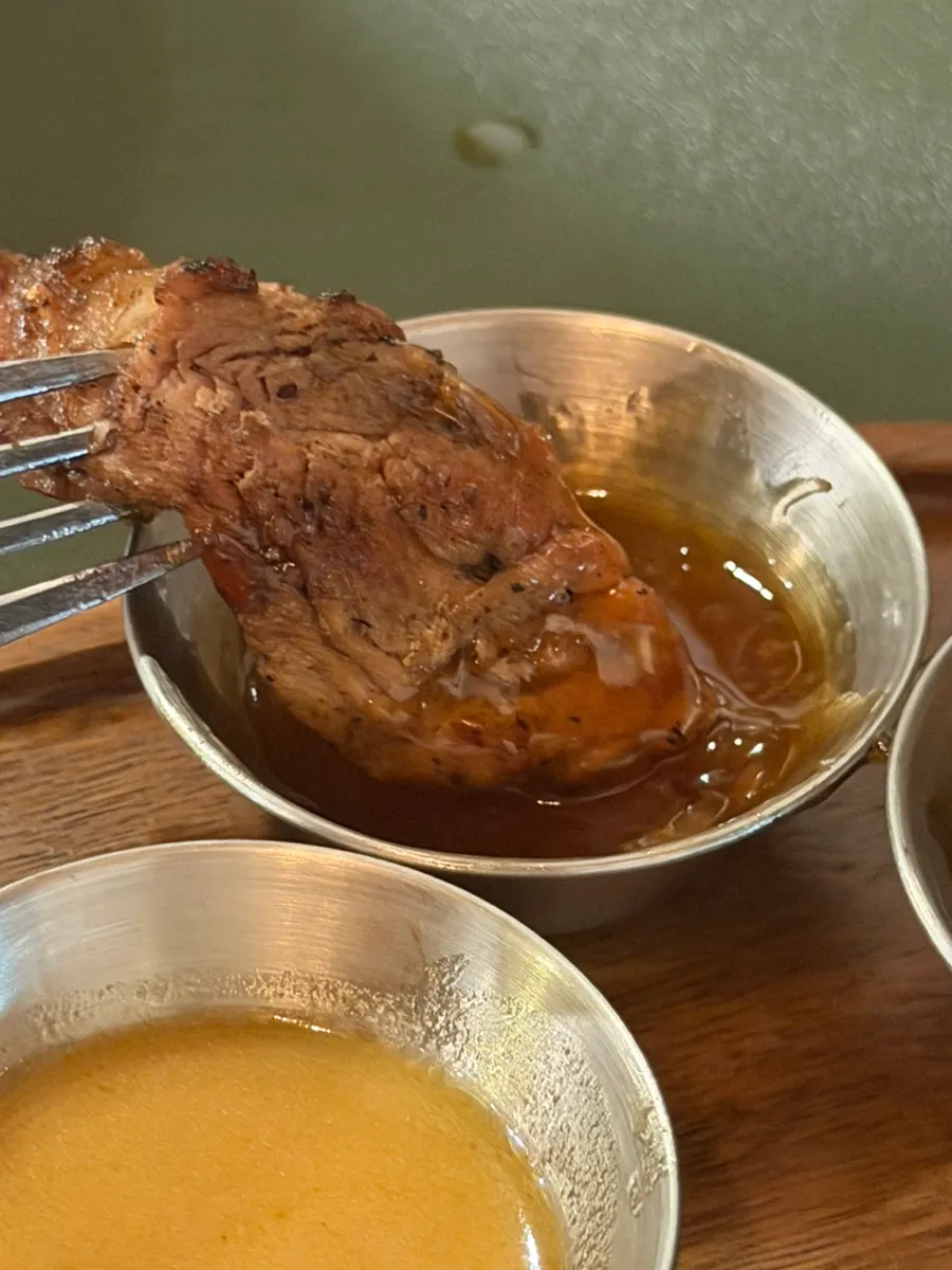Dipping meat into one of the sauces