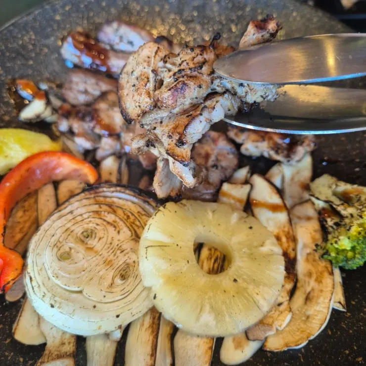 Close-up of pork belly-neck shashlik grilled over open flame