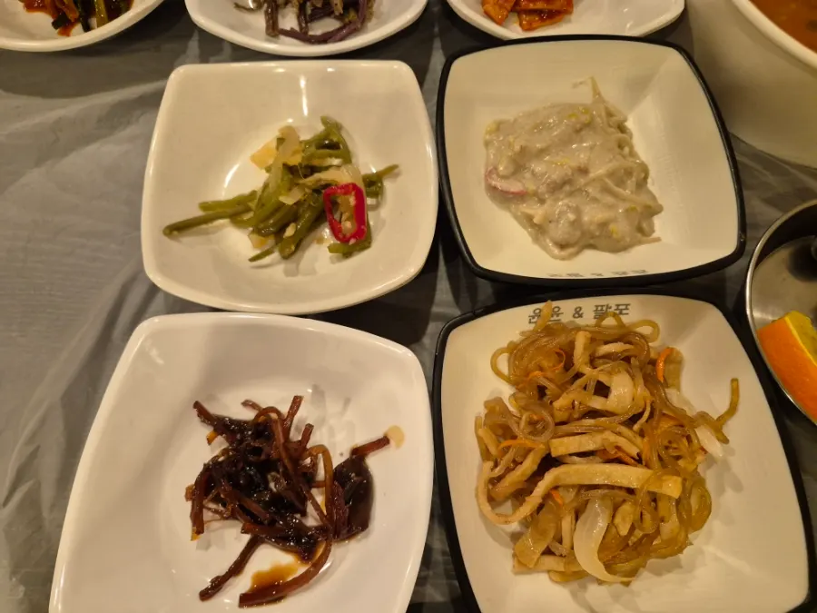 Side dishes including tofu kimchi and seasoned vegetables