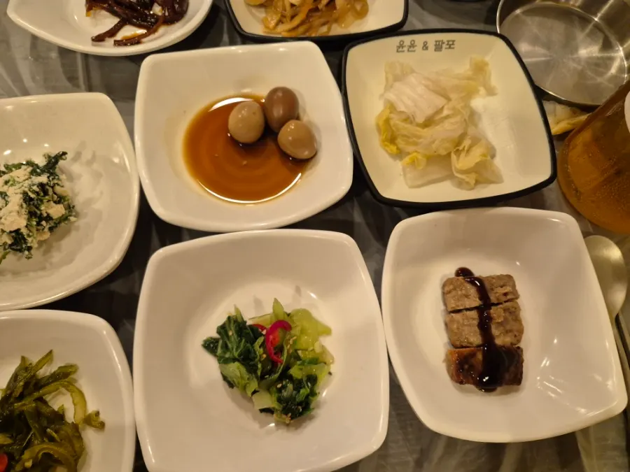 A variety of Korean side dishes laid out on the table