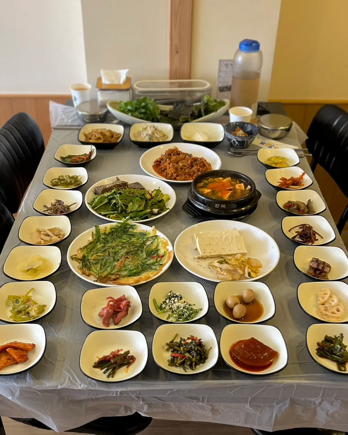 Spicy pork set for two, table packed with side dishes