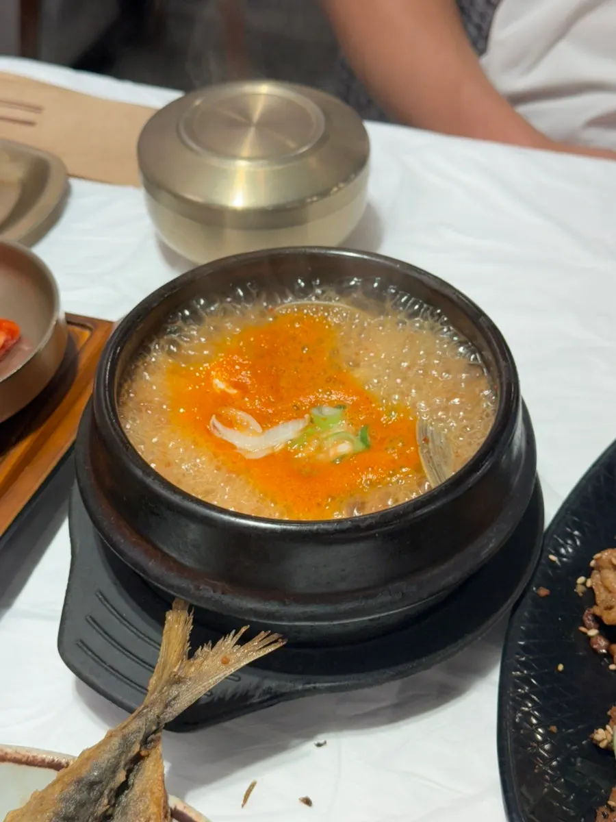 Table setting with a bubbling pot of doenjang jjigae