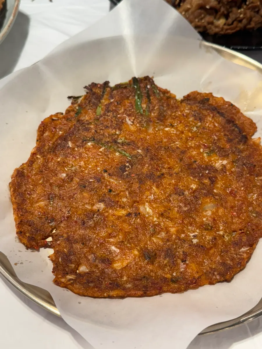 A whole grilled mackerel, crispy and well-cooked