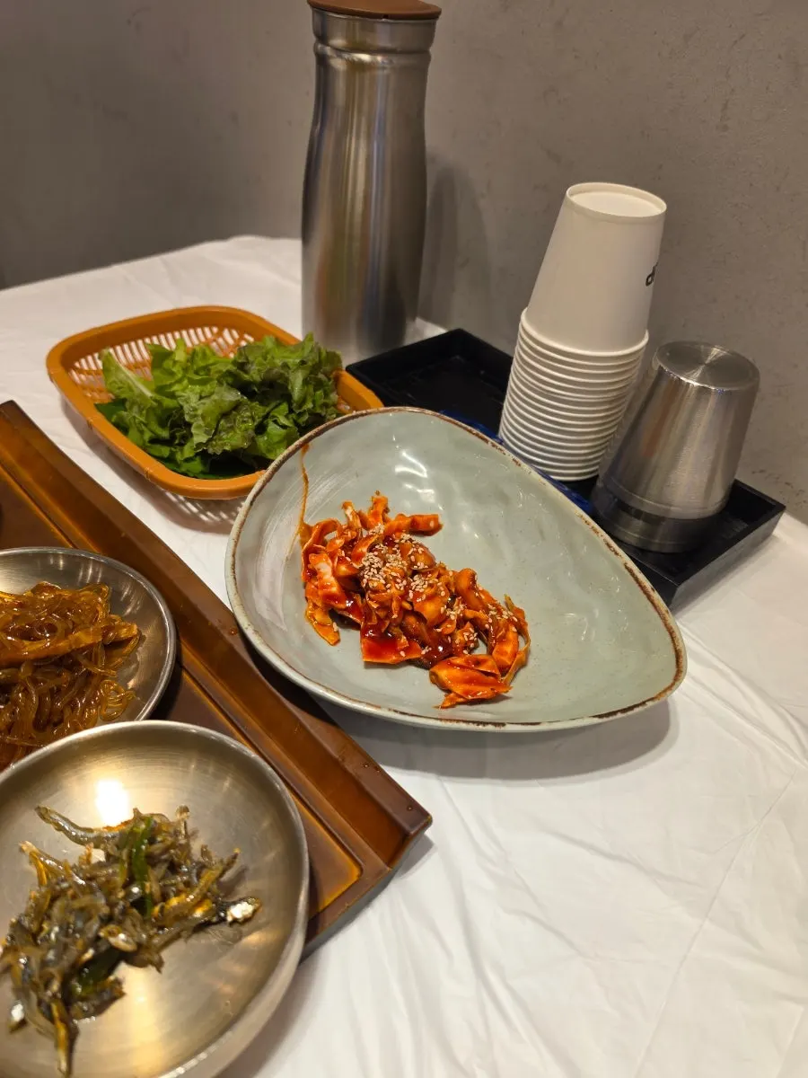 Steamed egg, seasoned vegetables, and spicy marinated crab side dishes