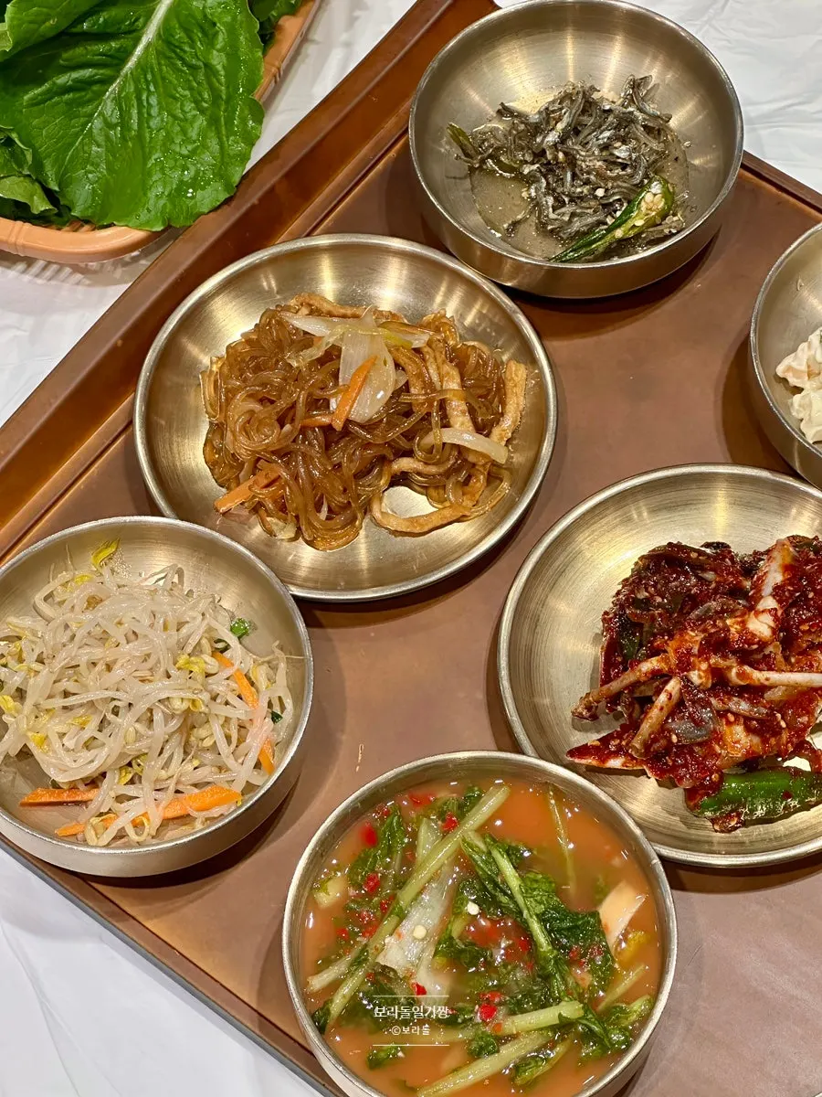 Plate of japchae, mung bean sprout salad and other Yun Sikdang banchan
