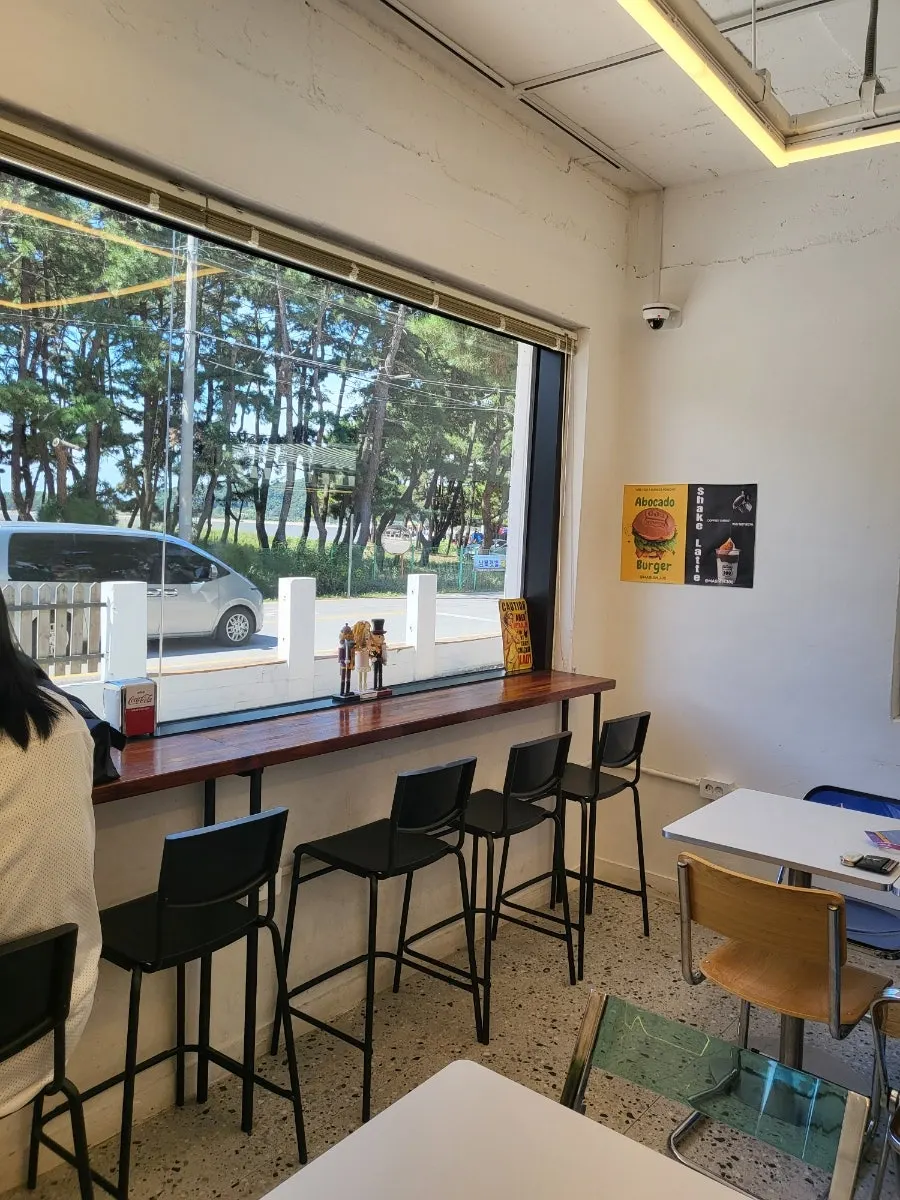 Indoor seating at Masian 300 with a view through the window