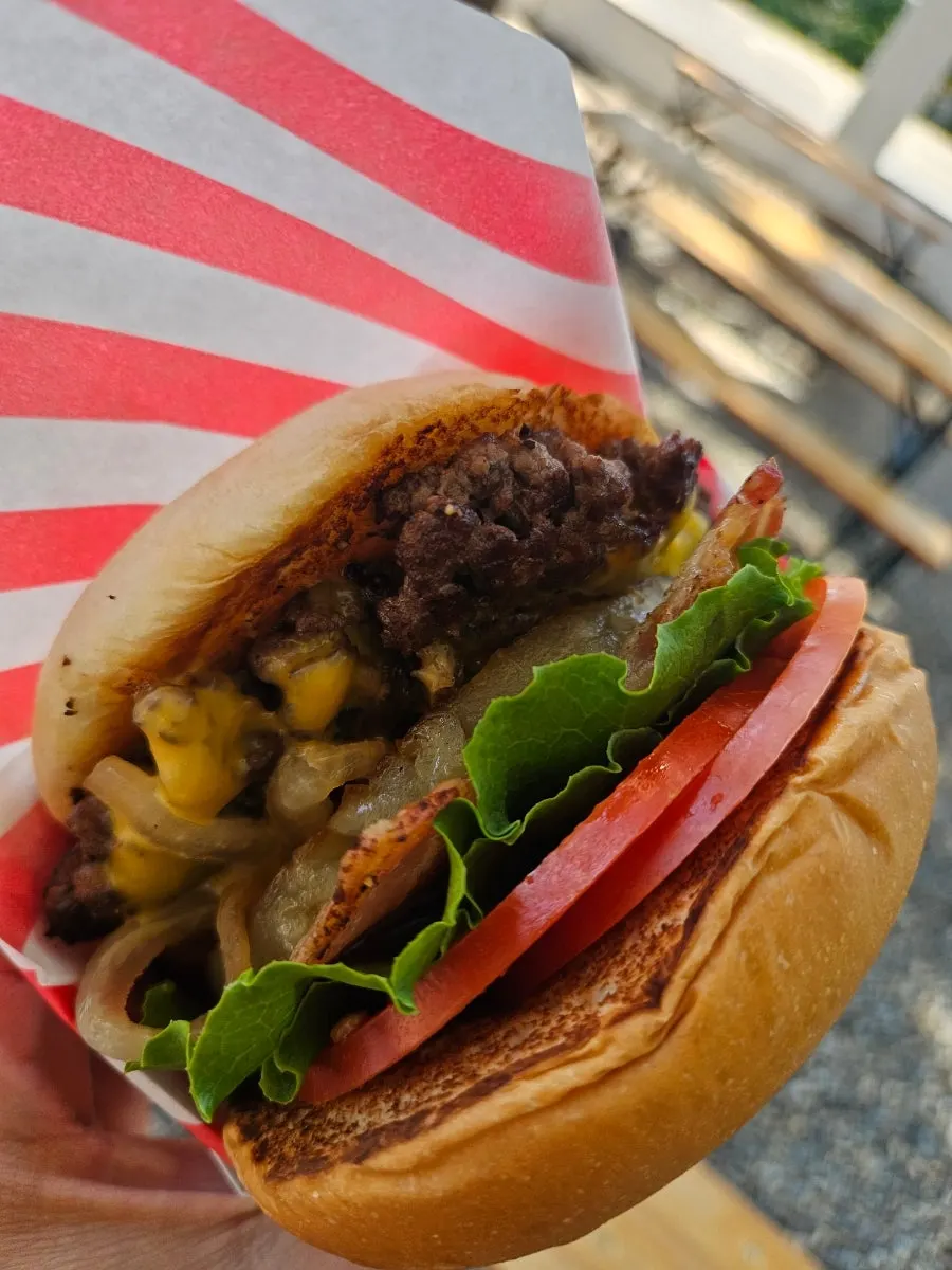 Cross-section of a bitten Hawaiian BBQ burger