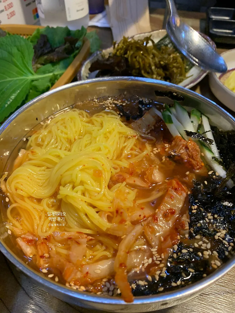 Kimchi-rolled noodles with tangy broth and chewy noodles