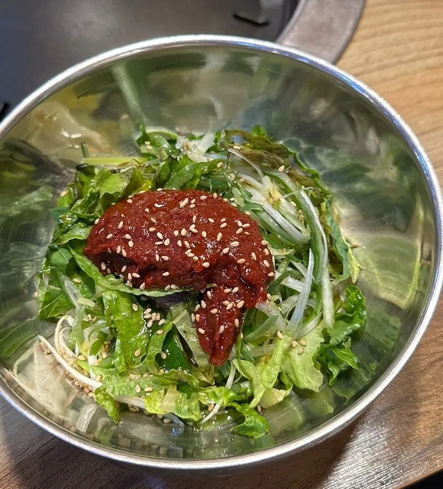 Pickled peppers, spicy radish salad, and scallion salad side dishes