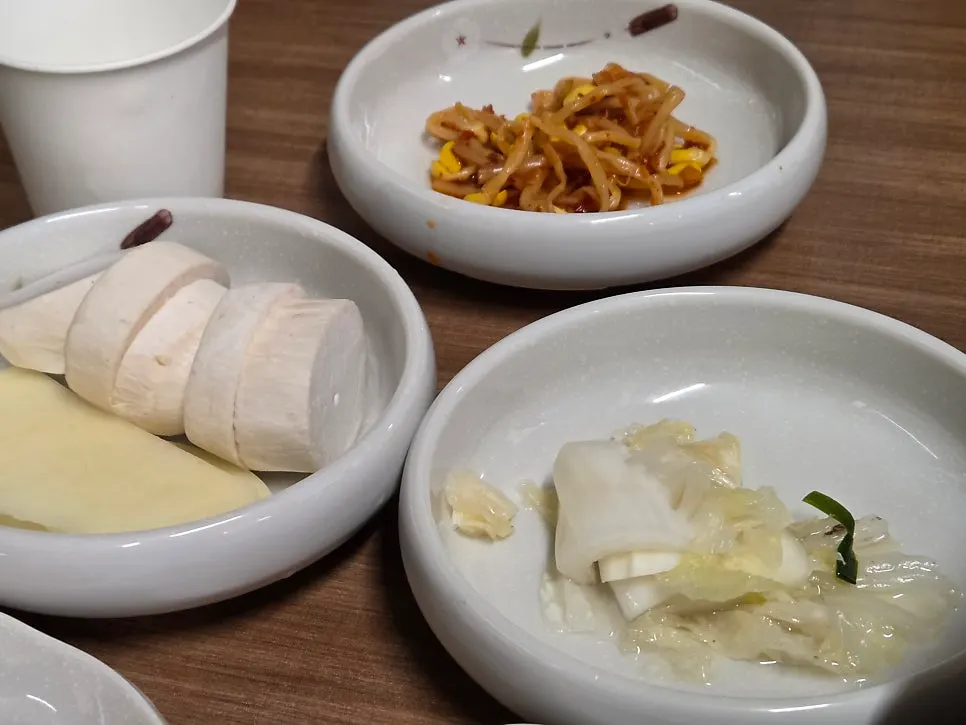 Lettuce wraps, sliced scallions and other basic side dishes at Matdongsam Beomeo