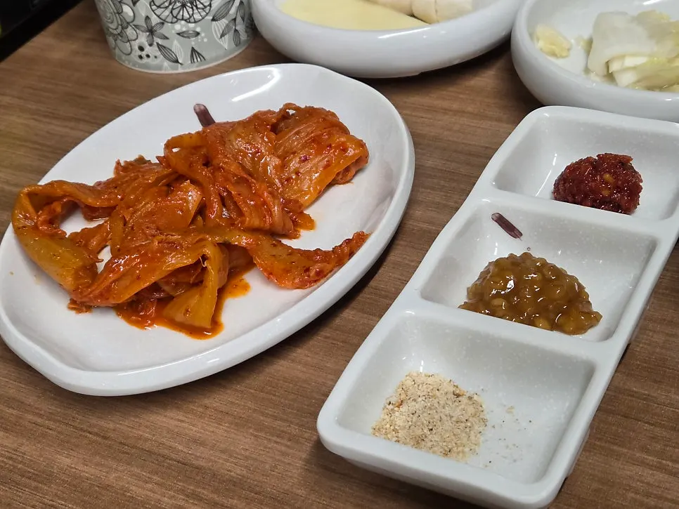 Table setting with pickled onions, ssamjang, and garlic