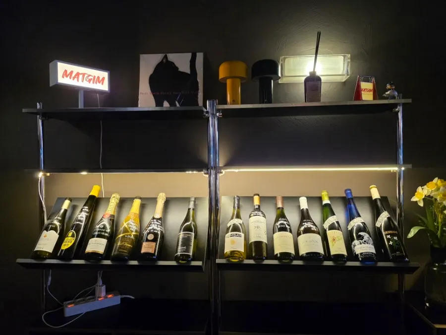 Wine bottles on display along one side of the restaurant