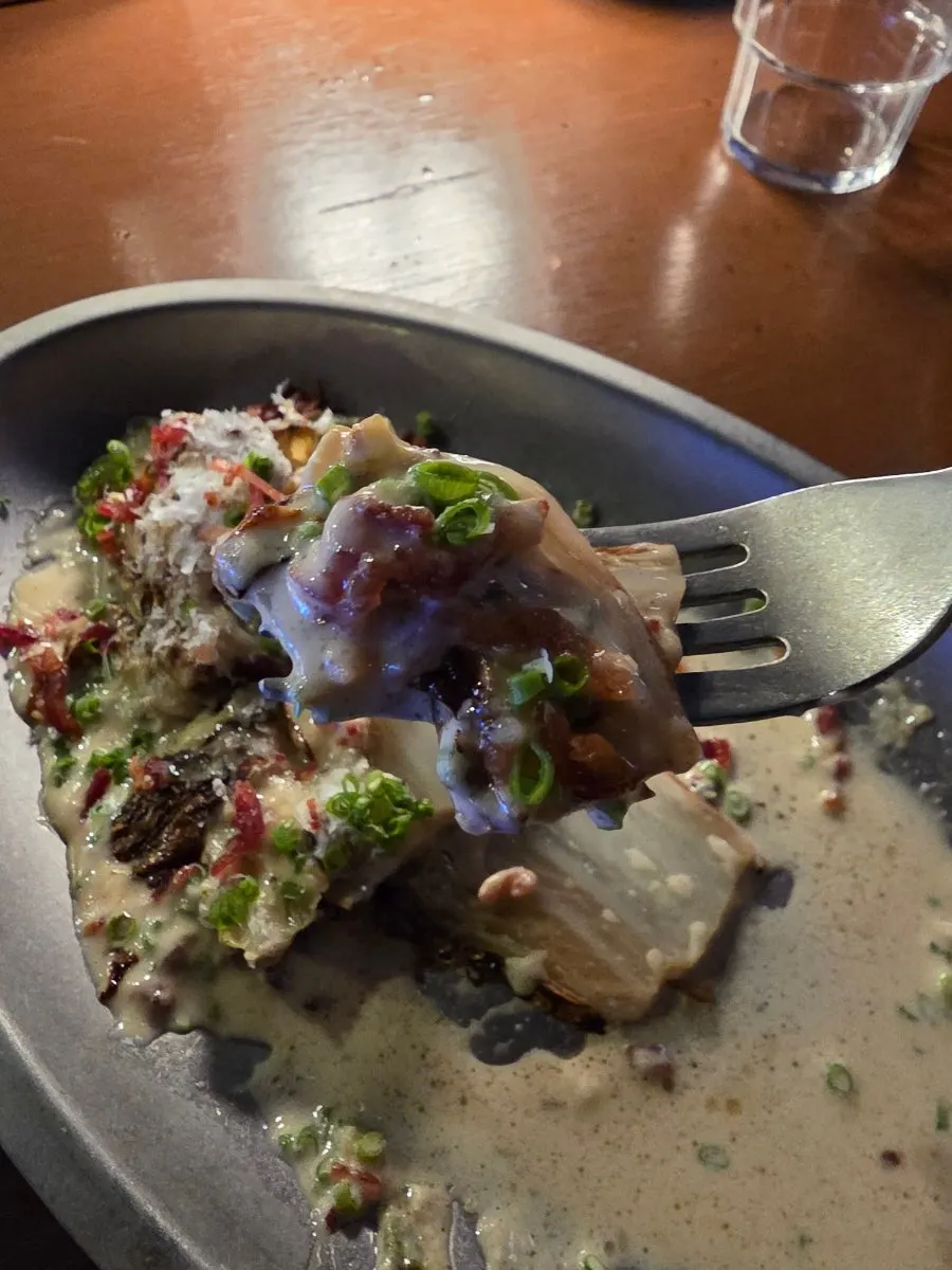 Plate of grilled baby cabbage with a portion taken out