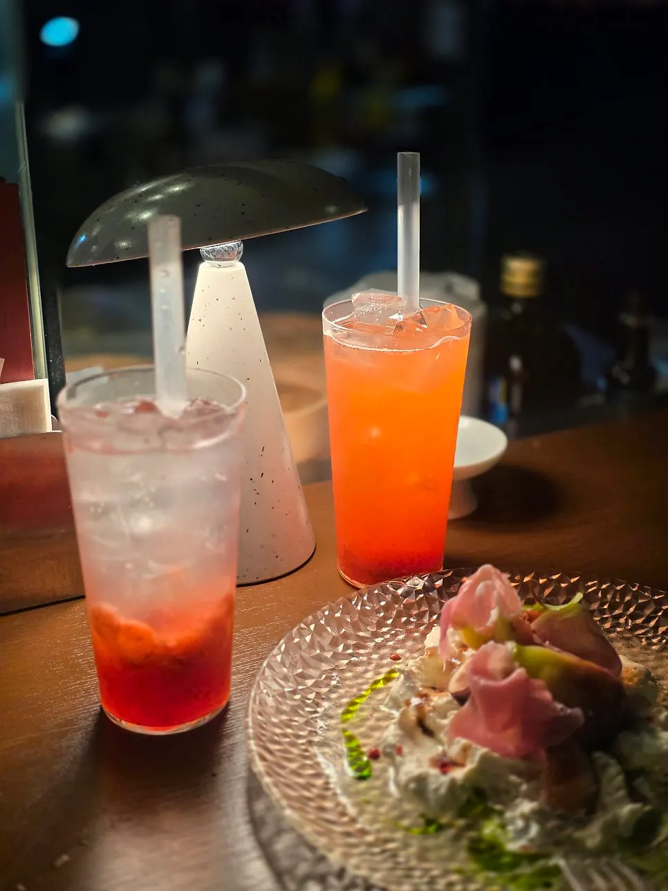Colorful drink served with prosciutto
