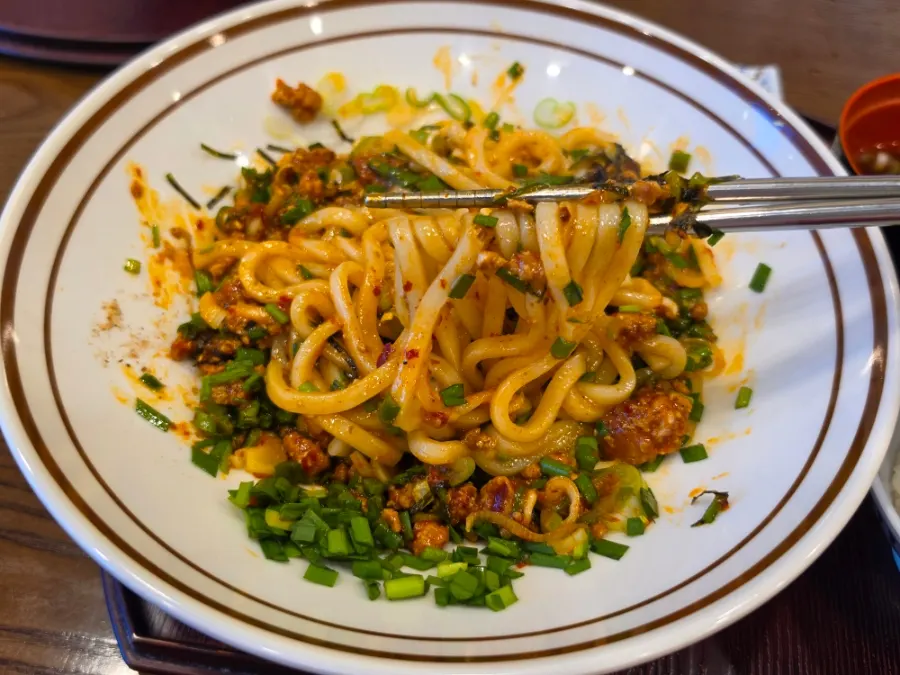 Mazesoba topped with egg yolk and ground meat