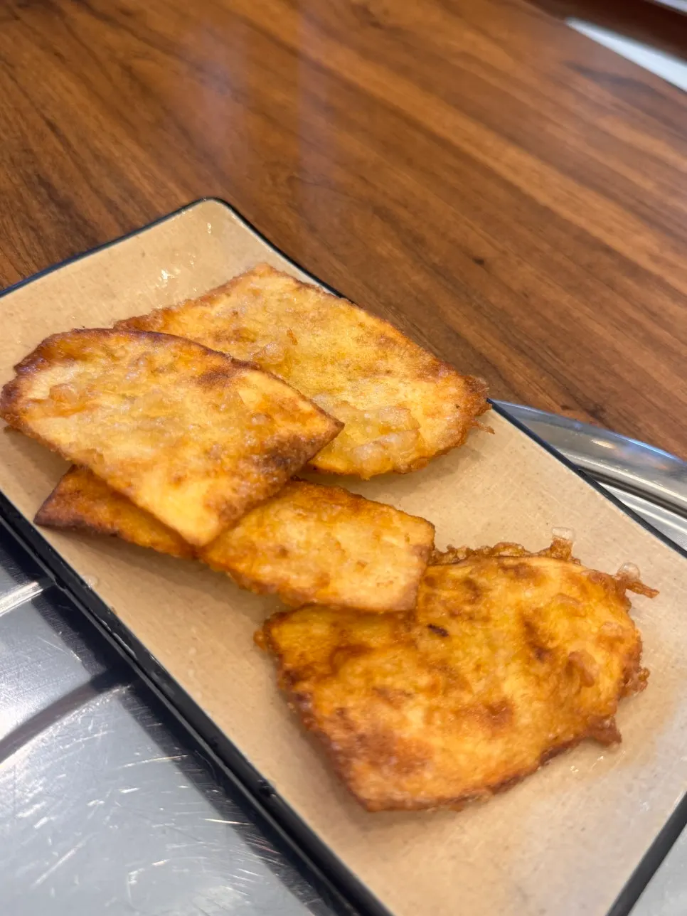 A warm piece of sweet potato fritter