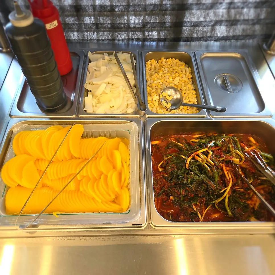 Self-serve corner with side dishes and rice