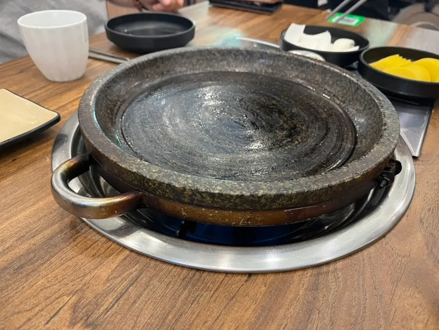 The empty stone griddle brought out first