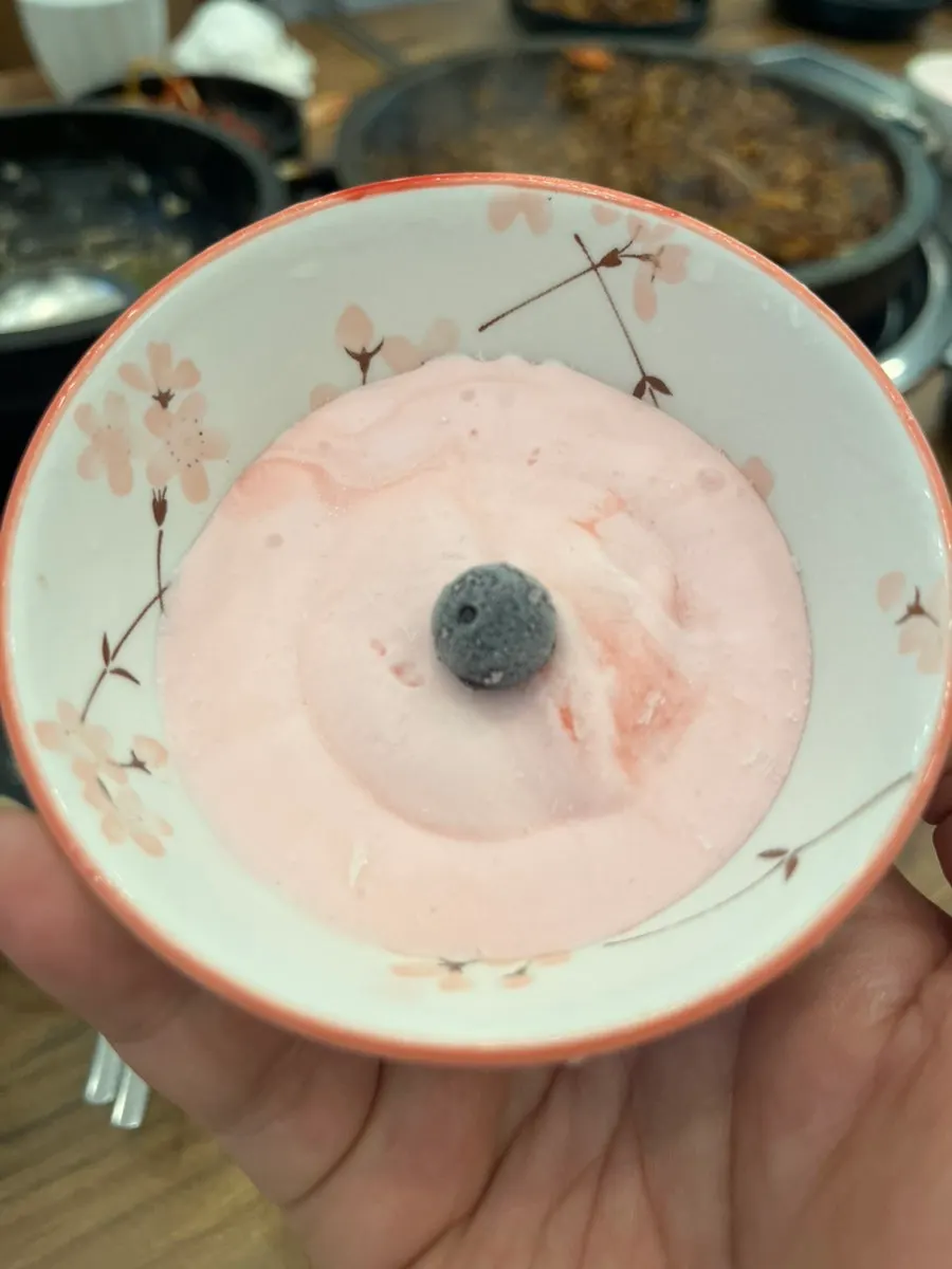 Free pink ice cream topped with a chocolate ball