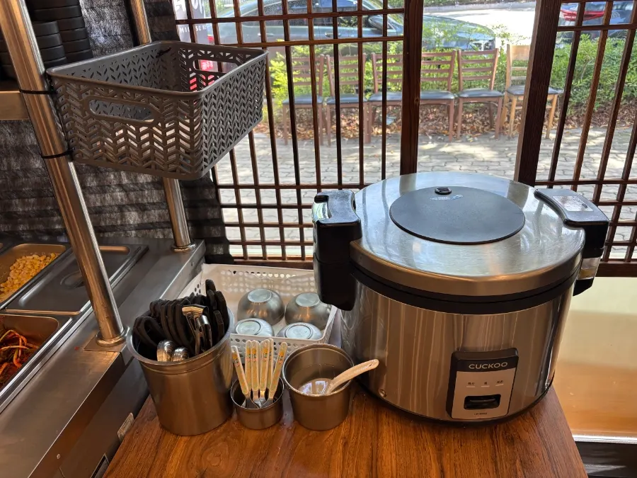 Self-serve bar with pickled radish, macaroni salad and scallion kimchi