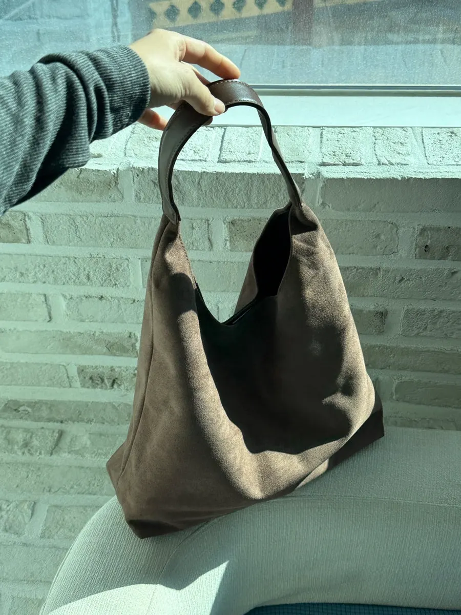 Meda Bag Suede Shoulder Bag at a café