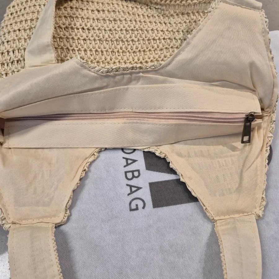 Interior storage pocket of the Meda Bag rattan bag
