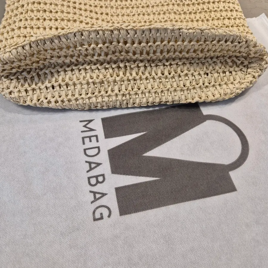 Stitching joining the lining and exterior of the rattan bag