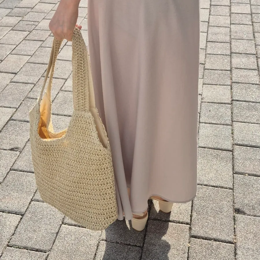 Checking the strap length of the Meda Bag rattan shoulder bag