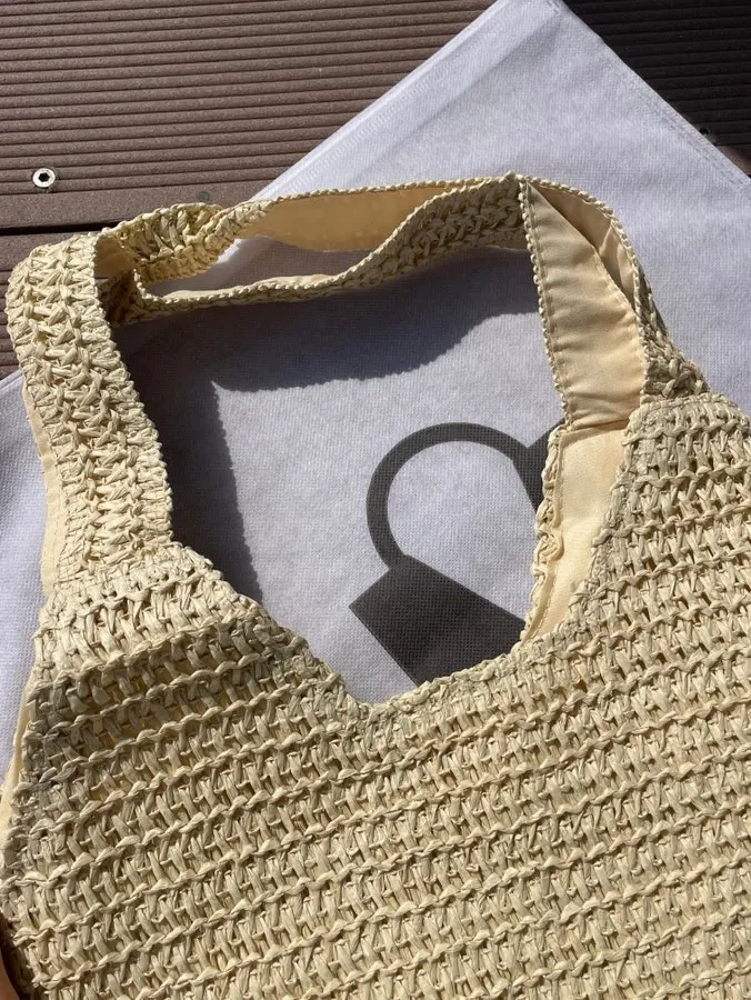 Checking the smooth texture of the Meda Bag rattan bag