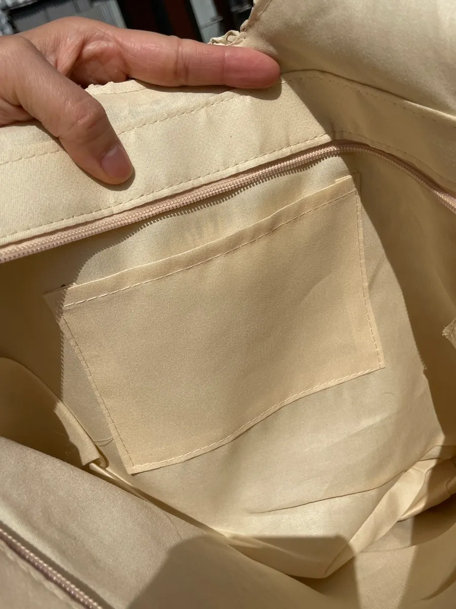Interior zip and storage space of the Meda Bag rattan bag